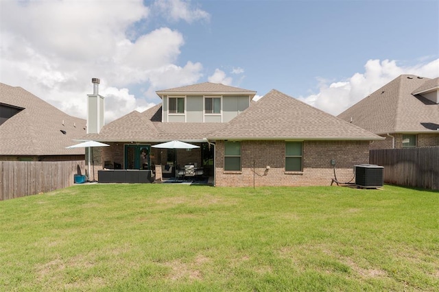 8208 Poplar Dr, Edmond, OK 73034 - rear view of house featuring cooling unit, a shingled roof, brick siding, a chimney, and a patio
