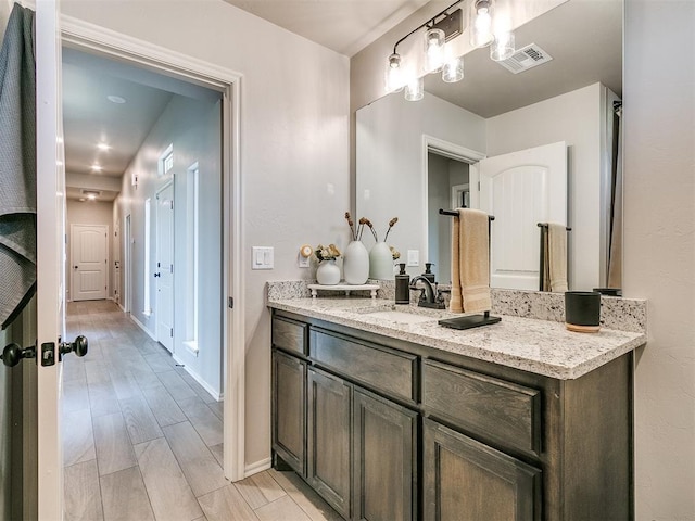 6965 Seabiscuit Ln, Guthrie, OK 73044 - bathroom featuring baseboards, vanity, and wood finished floors