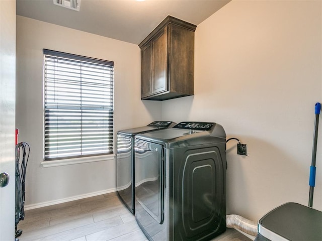 6965 Seabiscuit Ln, Guthrie, OK 73044 - clothes washing area featuring cabinet space, independent washer and dryer, plenty of natural light, and baseboards