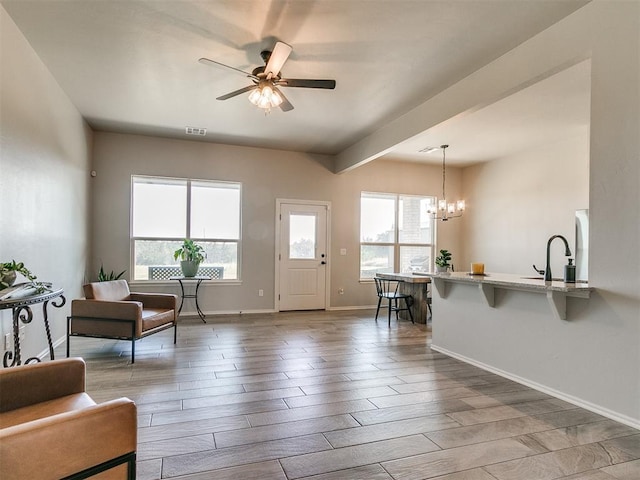 6965 Seabiscuit Ln, Guthrie, OK 73044 - foyer featuring wood finished floors, a ceiling fan, a chandelier, and baseboards
