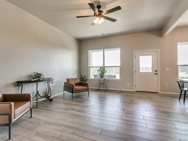 6965 Seabiscuit Ln, Guthrie, OK 73044 - living area featuring wood finished floors, ceiling fan, and baseboards