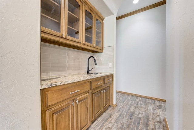 3401 Fox Hill Ter, Edmond, OK 73034 - bar with ornamental molding, tasteful backsplash, and light wood-type flooring