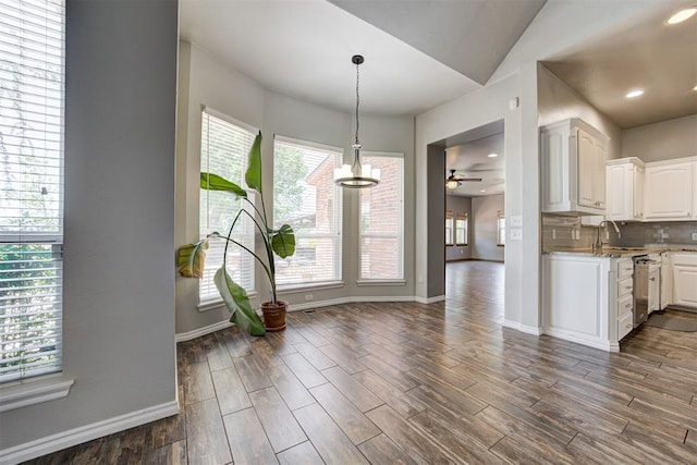 3401 Fox Hill Ter, Edmond, OK 73034 - kitchen featuring white cabinets, ceiling fan, decorative backsplash, dark wood-style floors, and decorative light fixtures