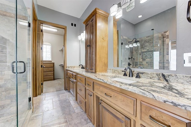 3401 Fox Hill Ter, Edmond, OK 73034 - bathroom with double vanity, a shower stall, and stone tile flooring