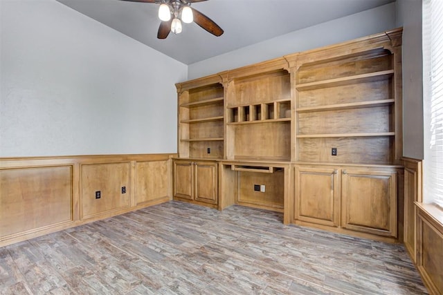 3401 Fox Hill Ter, Edmond, OK 73034 - unfurnished office with a ceiling fan, light wood finished floors, wainscoting, and a decorative wall