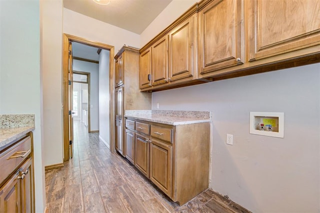 3401 Fox Hill Ter, Edmond, OK 73034 - laundry room featuring cabinet space, hookup for a washing machine, and light wood-style flooring