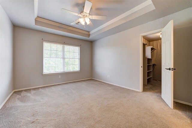 3401 Fox Hill Ter, Edmond, OK 73034 - empty room featuring crown molding, a raised ceiling, carpet flooring, and ceiling fan