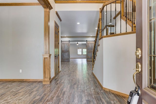 3401 Fox Hill Ter, Edmond, OK 73034 - entryway featuring ornamental molding, wood finished floors, stairway, a barn door, and recessed lighting