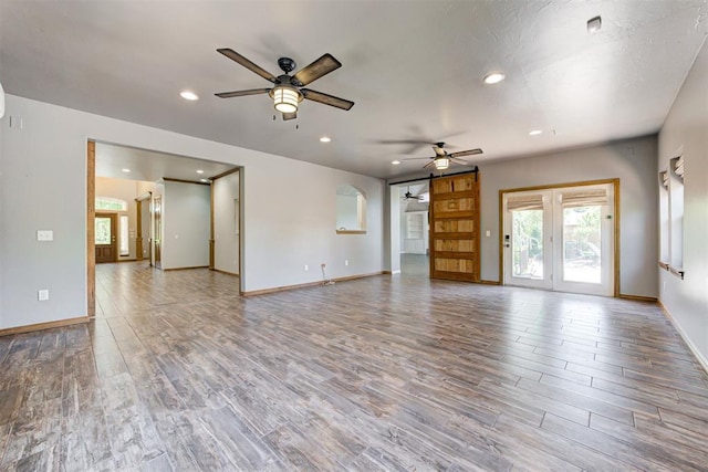 3401 Fox Hill Ter, Edmond, OK 73034 - unfurnished living room featuring ceiling fan, wood finished floors, and recessed lighting