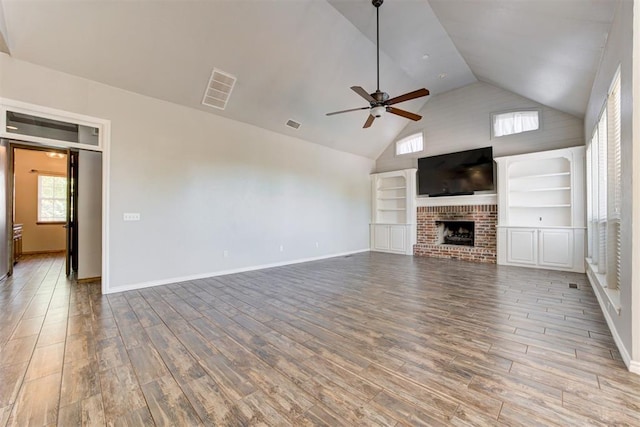 3401 Fox Hill Ter, Edmond, OK 73034 - unfurnished living room featuring ceiling fan, high vaulted ceiling, wood finished floors, and a brick fireplace