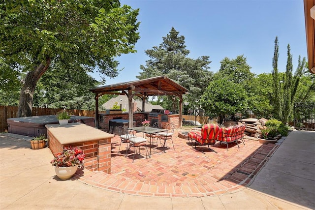 3401 Fox Hill Ter, Edmond, OK 73034 - fenced backyard with a hot tub, a gazebo, an outdoor kitchen, a patio area, and outdoor dining area
