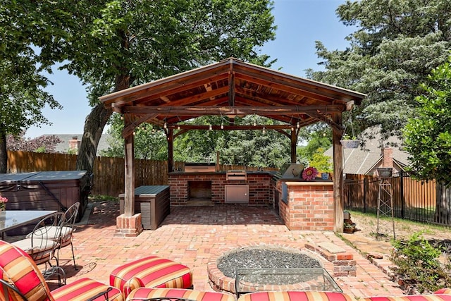 3401 Fox Hill Ter, Edmond, OK 73034 - fenced backyard featuring a hot tub, a gazebo, area for grilling, and a patio