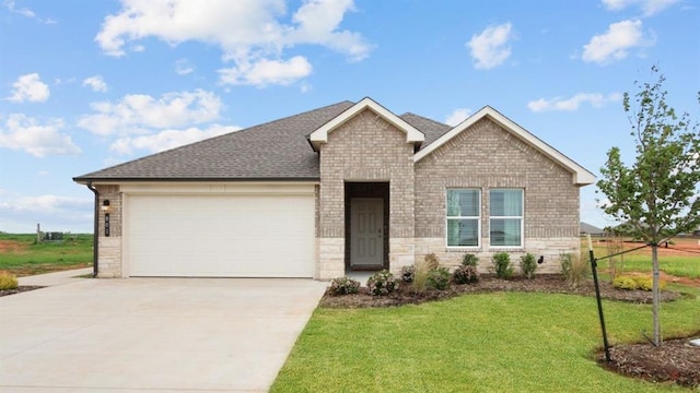 2504 Kathleens Xing, Yukon, OK 73099 - ranch-style home featuring brick siding, concrete driveway, a front lawn, an attached garage, and stone siding