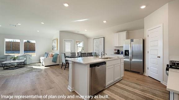 2504 Kathleens Xing, Yukon, OK 73099 - kitchen with stainless steel appliances, a sink, open floor plan, white cabinetry, and recessed lighting