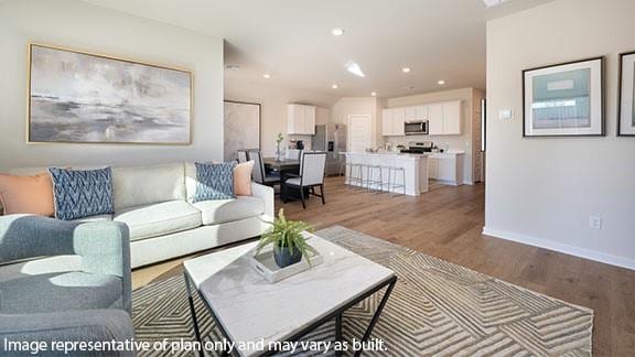 2504 Kathleens Xing, Yukon, OK 73099 - living room with light wood-type flooring, baseboards, and recessed lighting