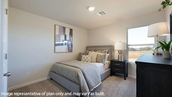 2504 Kathleens Xing, Yukon, OK 73099 - bedroom featuring light carpet and baseboards
