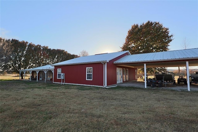 view of property exterior featuring a lawn and metal roof