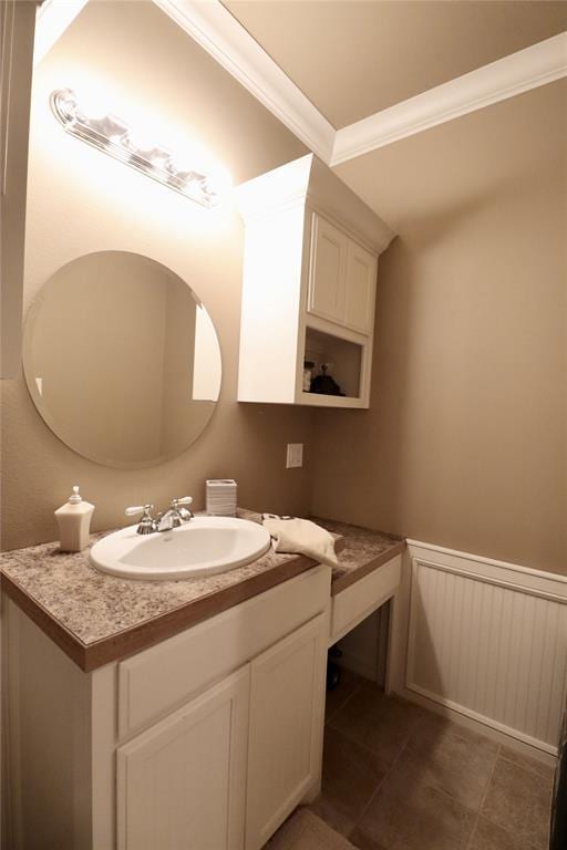 bathroom featuring ornamental molding, a wainscoted wall, vanity, and tile patterned floors