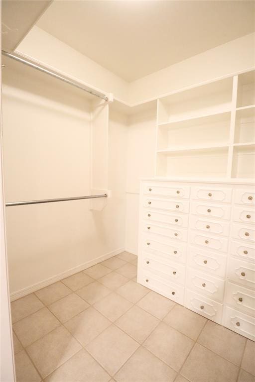 spacious closet featuring light tile patterned floors