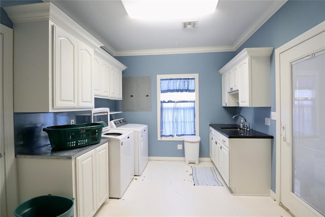 clothes washing area featuring a sink, separate washer and dryer, crown molding, and baseboards