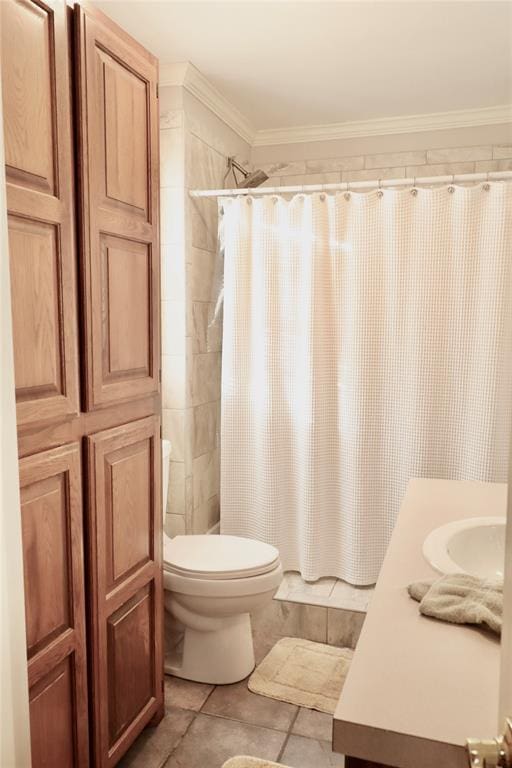 bathroom with a tile shower, tile patterned flooring, toilet, ornamental molding, and vanity