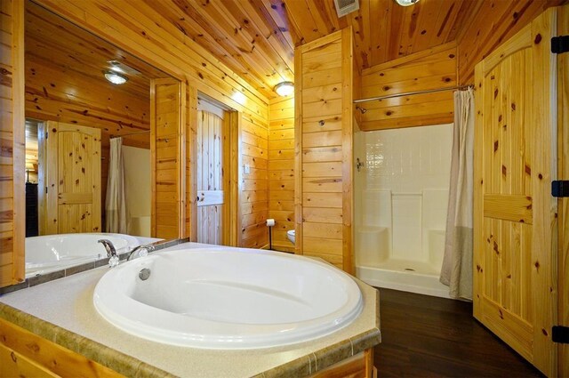 full bath with a shower stall, wood finished floors, wood ceiling, and wooden walls