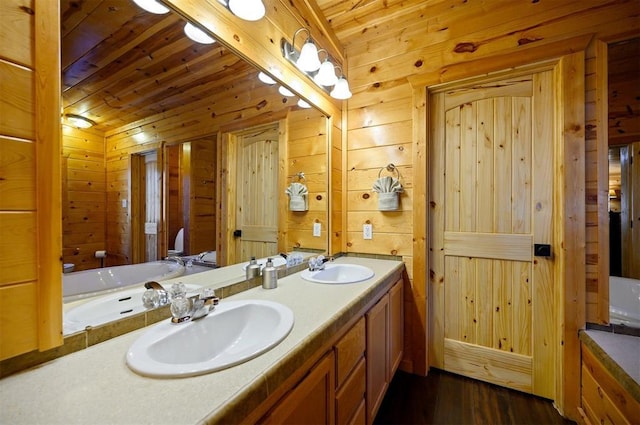 bathroom featuring wood walls, wood ceiling, double vanity, and wood finished floors
