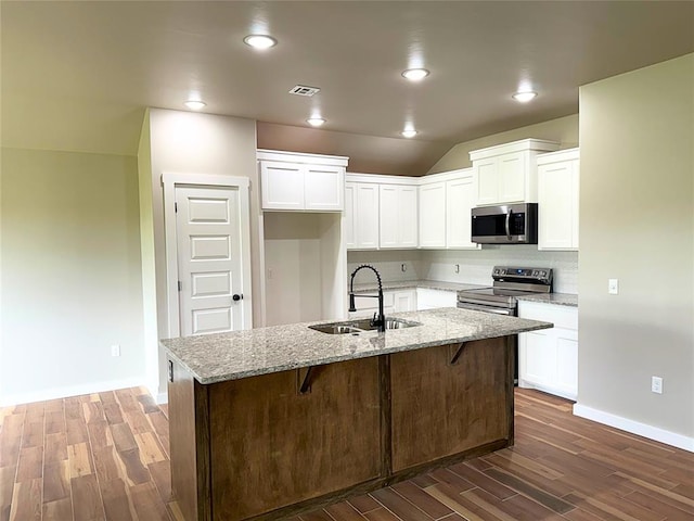 2476 County St Unit 2960, Blanchard, OK 73010 - kitchen featuring appliances with stainless steel finishes, dark wood-style floors, a sink, light stone countertops, and vaulted ceiling
