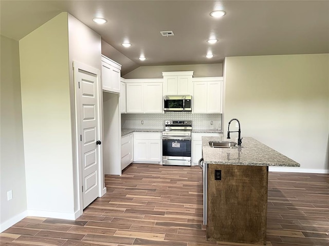 2476 County St Unit 2960, Blanchard, OK 73010 - kitchen with appliances with stainless steel finishes, a sink, wood finished floors, backsplash, and light stone counters