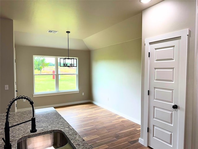 2476 County St Unit 2960, Blanchard, OK 73010 - kitchen featuring wood finished floors, a sink, stone counters, baseboards, and decorative light fixtures