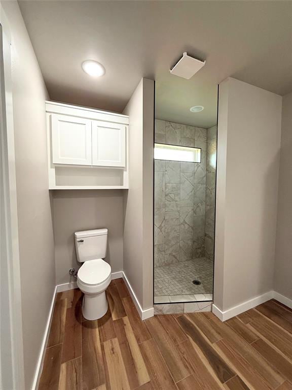 2476 County St Unit 2960, Blanchard, OK 73010 - full bathroom featuring wood finished floors, toilet, a tile shower, and baseboards