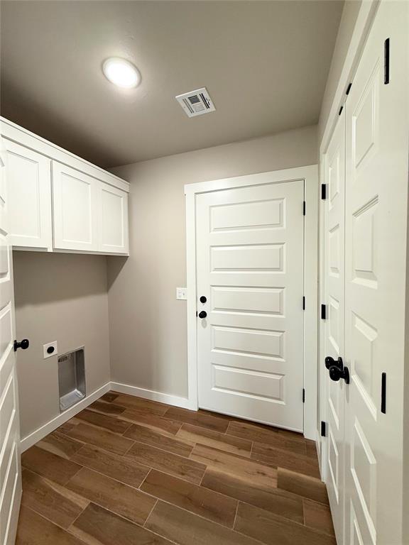 2476 County St Unit 2960, Blanchard, OK 73010 - laundry area featuring hookup for an electric dryer, dark wood-type flooring, cabinet space, and baseboards