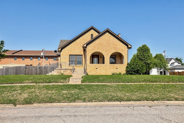 100 S Macomb Ave, El Reno, OK 73036 - view of front of home featuring brick siding and a chimney