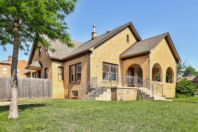 100 S Macomb Ave, El Reno, OK 73036 - rear view of house with brick siding, a chimney, and roof with shingles