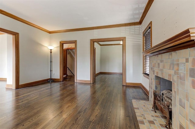 100 S Macomb Ave, El Reno, OK 73036 - unfurnished living room featuring hardwood / wood-style floors, ornamental molding, baseboards, and a fireplace