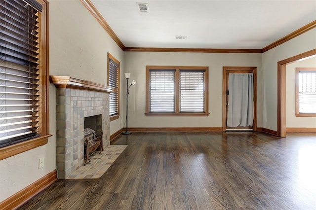 100 S Macomb Ave, El Reno, OK 73036 - unfurnished living room featuring wood finished floors, baseboards, a tiled fireplace, and ornamental molding