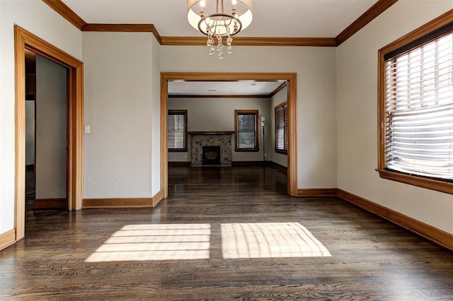100 S Macomb Ave, El Reno, OK 73036 - empty room with ornamental molding, a chandelier, wood finished floors, baseboards, and a fireplace