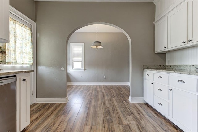 100 S Macomb Ave, El Reno, OK 73036 - kitchen featuring dishwasher, arched walkways, baseboards, and white cabinets