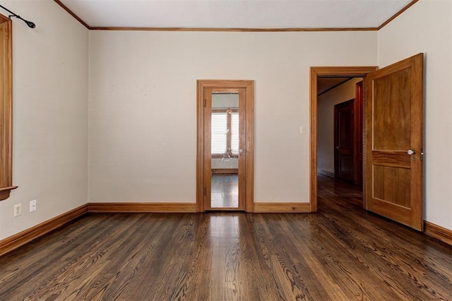 100 S Macomb Ave, El Reno, OK 73036 - empty room featuring baseboards, crown molding, and dark wood finished floors