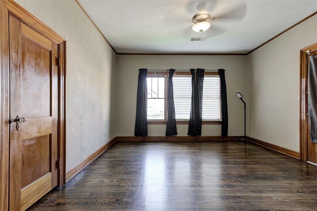 100 S Macomb Ave, El Reno, OK 73036 - empty room with dark wood finished floors, ornamental molding, a textured wall, and baseboards