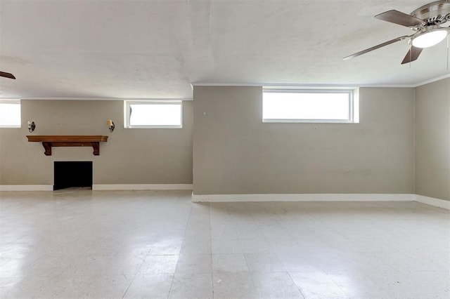 100 S Macomb Ave, El Reno, OK 73036 - basement with a ceiling fan, a fireplace, healthy amount of natural light, crown molding, and baseboards