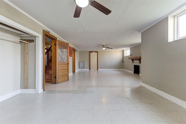 100 S Macomb Ave, El Reno, OK 73036 - unfurnished living room with a ceiling fan, baseboards, and light floors