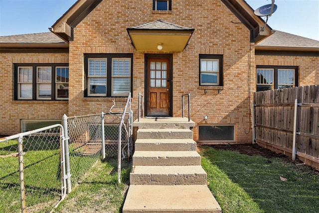 100 S Macomb Ave, El Reno, OK 73036 - view of exterior entry with brick siding and roof with shingles