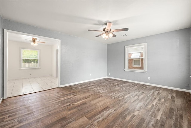 2545 W Eubanks St, Oklahoma City, OK 73112 - empty room featuring a ceiling fan, wood finished floors, and baseboards
