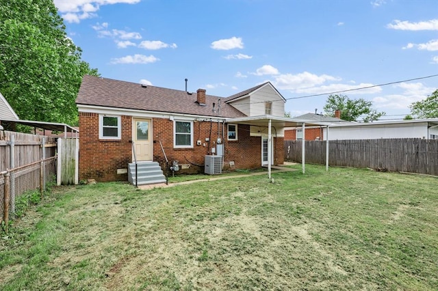 2545 W Eubanks St, Oklahoma City, OK 73112 - back of property featuring central AC unit, brick siding, entry steps, and a shingled roof