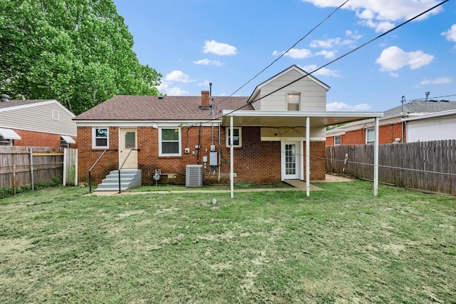 2545 W Eubanks St, Oklahoma City, OK 73112 - rear view of property featuring brick siding, central AC unit, a shingled roof, and a chimney