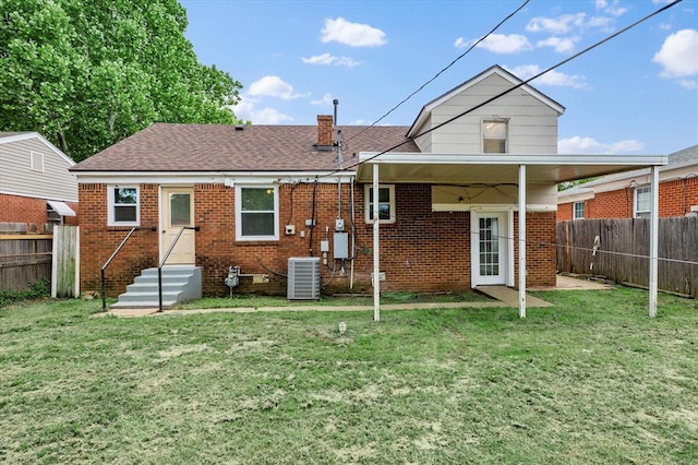 2545 W Eubanks St, Oklahoma City, OK 73112 - back of property with central AC unit, brick siding, roof with shingles, and a chimney