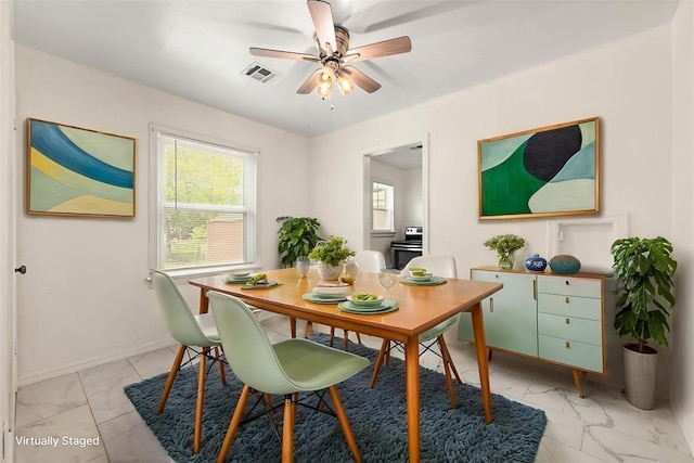 2545 W Eubanks St, Oklahoma City, OK 73112 - dining area with light marble finish floors, a ceiling fan, and baseboards