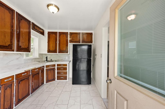 2545 W Eubanks St, Oklahoma City, OK 73112 - kitchen featuring freestanding refrigerator, a sink, light marble finish flooring, and light countertops