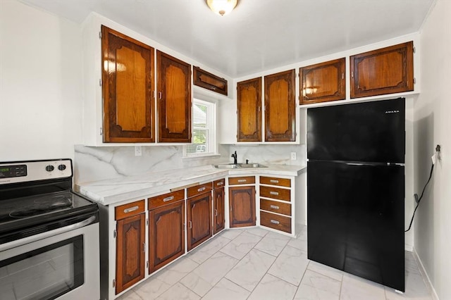 2545 W Eubanks St, Oklahoma City, OK 73112 - kitchen with freestanding refrigerator, stainless steel range with electric cooktop, a sink, light marble finish flooring, and light countertops